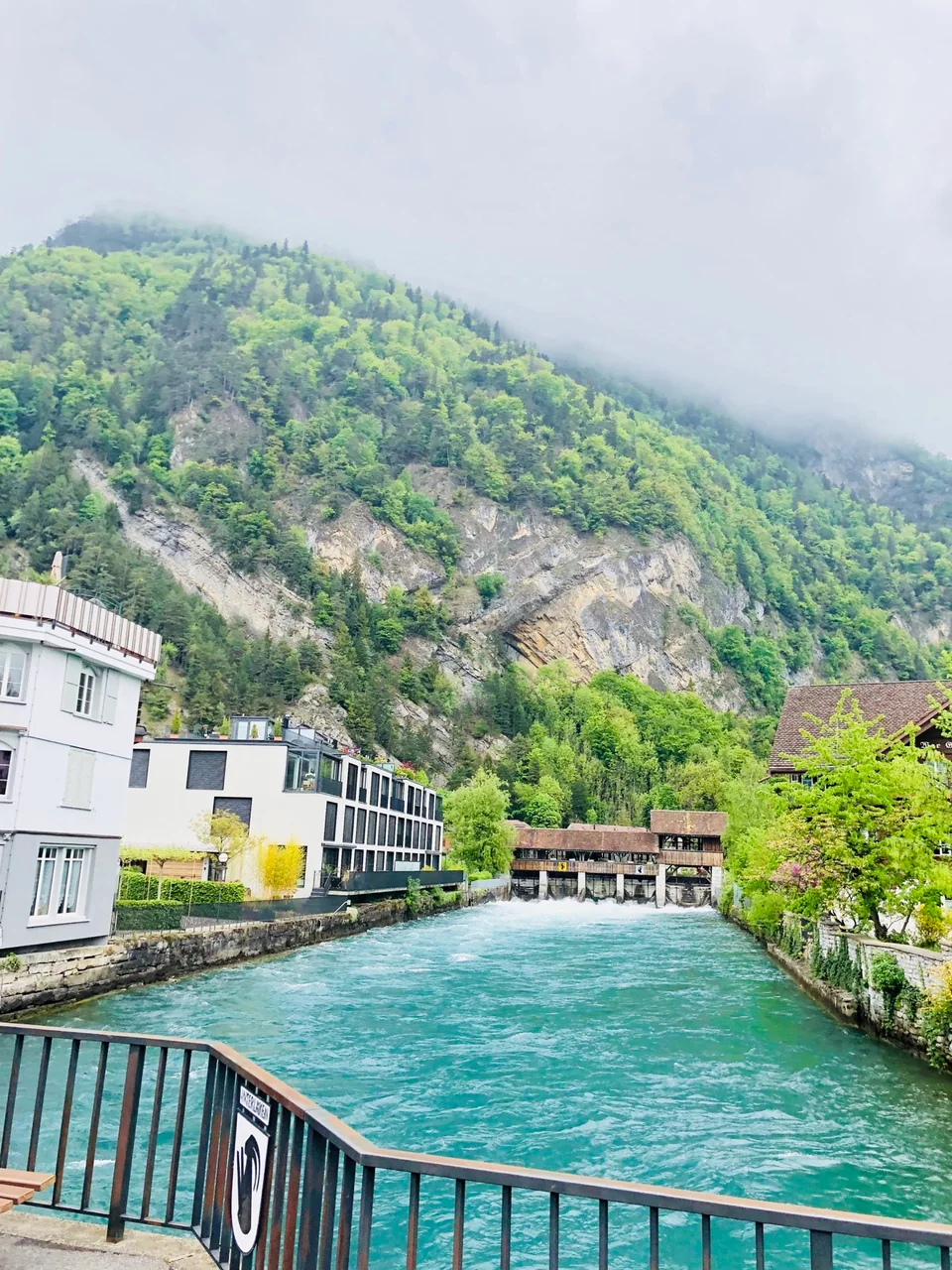 A turquoise river in Interlaken with mountains beyond